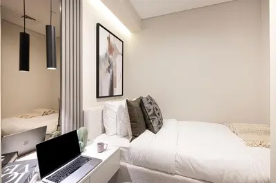 a living room with a laptop on a white couch at Elite 4 Bedroom Luxury Apartment, Burj Khalifa View, Opposite Dubai Mall, Infinity Swimming Pool in Dubai
