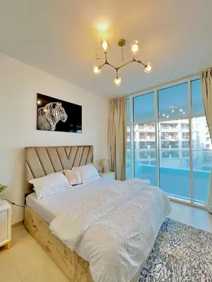 a bedroom with a bed and a tv on the wall at Azizi Mina - Palm Jumeirah in Dubai