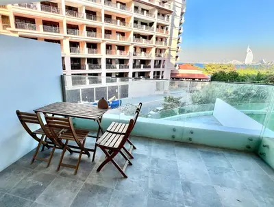 a table and chairs on a balcony with a view at Azizi Mina - Palm Jumeirah in Dubai