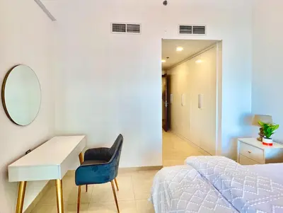 a bedroom with a desk and a bed and a mirror at Azizi Mina - Palm Jumeirah in Dubai