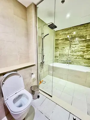 a bathroom with a toilet and a shower at Azizi Mina - Palm Jumeirah in Dubai