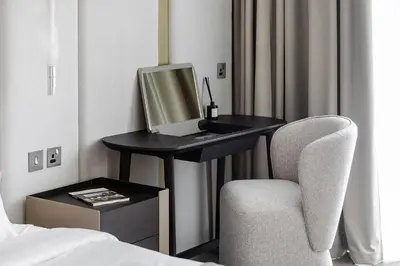 a desk with a computer and a chair in a hotel room at Modern Stylish Studio Apartment next to Burj Khalifa walk into Dubai mall in Dubai