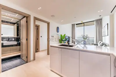 a kitchen with white cabinets and a sink at Close Proximity to Leisure Areas and City View 1BR, Binghatti Corner, Jumeirah Village Circle by Deluxe Holiday Homes in Dubai