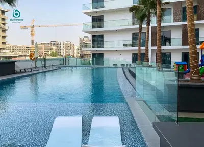 a swimming pool on the roof of a building at Blue Breeze - Chic & Cozy 1 BR Getaway in Al Furjan in Dubai