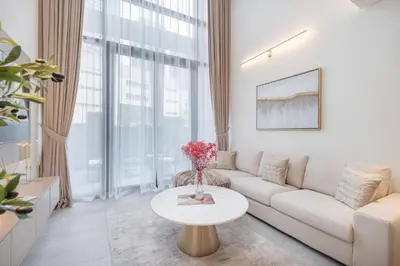 a living room with a couch and a table at Elegant 1BHK by CzechIn Luxe Stay with Pool and Gym in Dubai