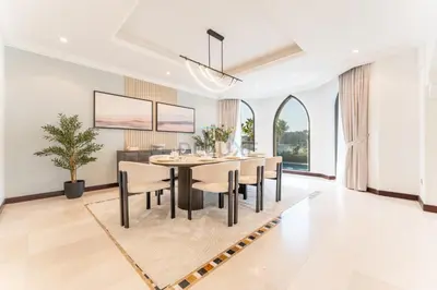 a dining room with a table and chairs at Beachfront 6BR and Assistant's Room Villa with Private Pool, Palm Villa, Palm Jumeirah by Deluxe Holiday Homes in Dubai