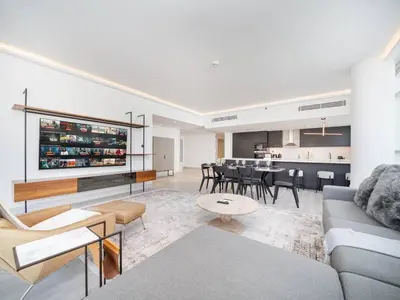a living room with a couch and a table at Waterfront Dubai Marina 3-Bedroom Sanctuary in Dubai