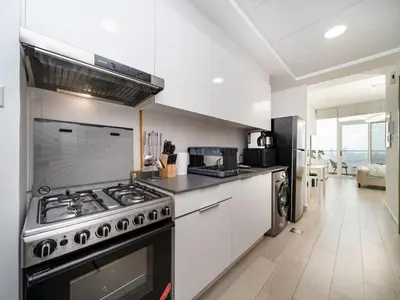 a kitchen with a stove and a counter top at Elegant Studio in Bloom JVC with High-End Finishes in Dubai
