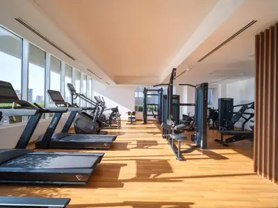 a gym with treadmills and elliptical machines at Elegant Studio in Bloom JVC with High-End Finishes in Dubai