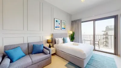 a bedroom with a bed and a couch at Mag 980 - Cosy Studio with City Views in Meydan in Dubai