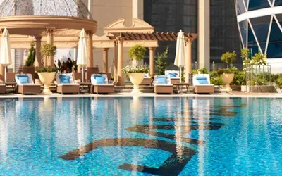 a swimming pool with lounge chairs and a building at GuestReady - Upscale living near Downtown Dubai in Dubai