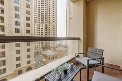 a balcony with a chair and a view of a city at GuestReady - Contemporary Apt in JBR in Dubai