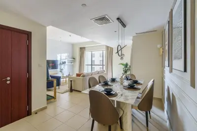 a dining room and living room with a table and chairs at GuestReady - Contemporary Apt in JBR in Dubai