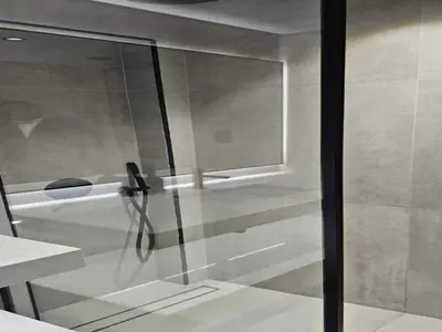 a shower with a glass door in a bathroom at Luxury Studio in JVC in Dubai