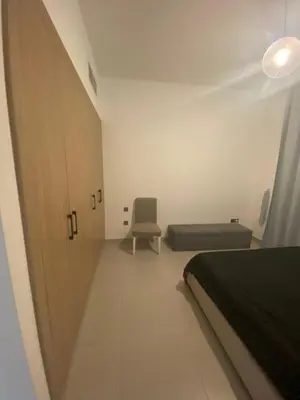 a bedroom with a bed and a chair and a door at 2Bedroom Apartment for Rent Fully Furnished ,Spacious in Dubai