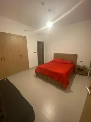 a bedroom with a bed with a red blanket at 2Bedroom Apartment for Rent Fully Furnished ,Spacious in Dubai