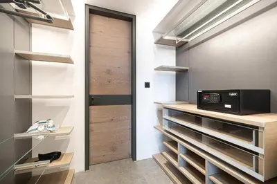 a kitchen with wooden shelves and a microwave at 1-Bedroom Apartment with Greenery & City Views in The Terraces in Dubai