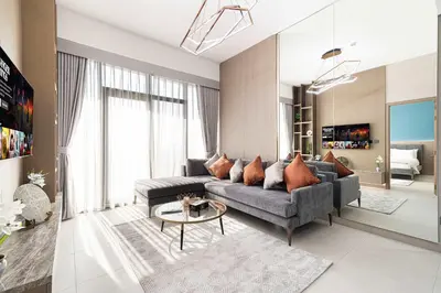 a living room with a couch and a table at Spacious 1BR with Modern Amenities in Westwood Grande JVC in Dubai