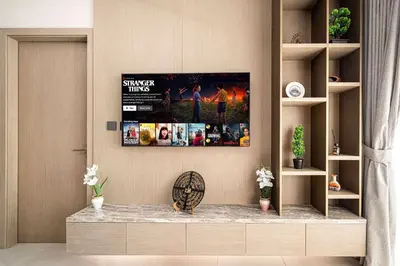 a living room with a tv on the wall at Spacious 1BR with Modern Amenities in Westwood Grande JVC in Dubai