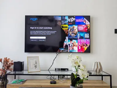 a tv hanging on a wall in a living room at Modern Luxury Fully Furnished 1BH Apartment in Binghatt Nova JVC - Easy Access to JBR, Circle Mall & Dubai Hills Mall in Dubai