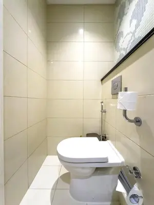 a bathroom with a toilet and a sink at Spacious 1BR - Balcony & Pool View - Capital Bay in Dubai