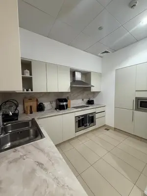 a large kitchen with white cabinets and a sink at TYS EXCELLENCE luxury apartment Palm Jumeirah DUBAI in Dubai