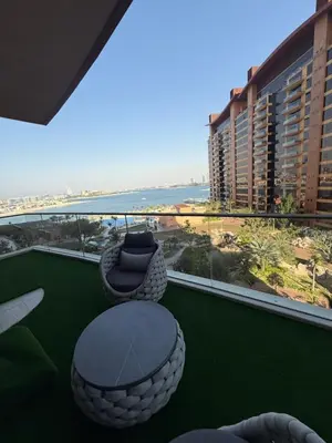 a balcony with a table and chairs and a view of the ocean at TYS EXCELLENCE luxury apartment Palm Jumeirah DUBAI in Dubai
