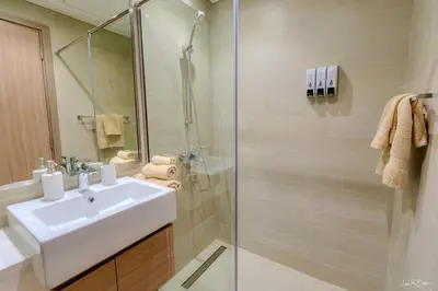 a bathroom with a sink and a shower at Burj Khalifa View studio in Dubai