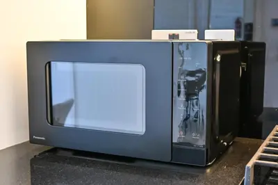a microwave oven sitting on top of a counter at The Pad Burj Khalifa view 1Bd in Dubai