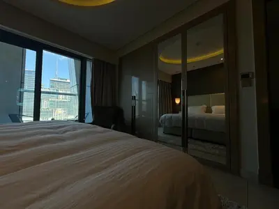 a hotel room with a bed and a large window at HollywoodDXB Burj Khalifa View - 6Min To Dubai Mall in Dubai