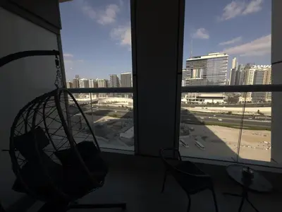 a room with a hammock and a view of a city at HollywoodDXB Burj Khalifa View - 6Min To Dubai Mall in Dubai
