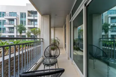 two chairs on the balcony of a building at HAVN - Studio in Downtown, 10mins to Dubai Mall in Dubai