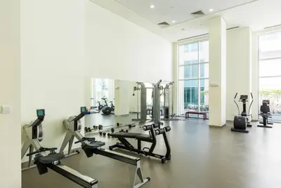 a gym with treadmills and ellipticals in a room at HAVN - Studio in Downtown, 10mins to Dubai Mall in Dubai