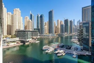 a view of a city with boats in the water at Dubai Marina View - 2BR APT with Pool & Gym in Dubai