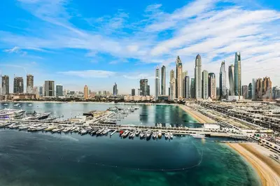 a view of a city with a harbor with boats at Sea View 2BR Near Beach Marina Walk & Dining Spots in Dubai