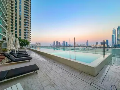 a large swimming pool on the roof of a building at Sea View 2BR Near Beach Marina Walk & Dining Spots in Dubai