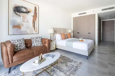 a living room with a bed and a couch at Frank Porter - Peninsula Five in Dubai
