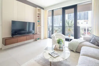 a living room with a tv and a couch and a table at Frank Porter - Boulevard Heights in Dubai