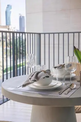 a table with a plate of food and wine glasses at Frank Porter - Boulevard Heights in Dubai