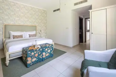 a bedroom with a bed and a table in it at Frank Porter - The Residences 5 in Dubai