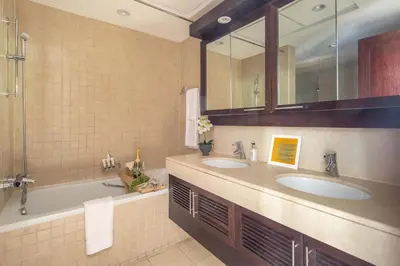 a bathroom with two sinks and a tub at Frank Porter - The Residences 5 in Dubai