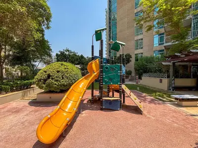 a yellow slide in a playground in a city at Frank Porter - The Residences 5 in Dubai