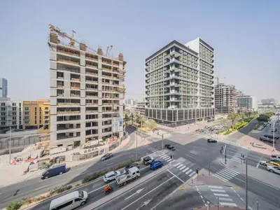an aerial view of a city with tall buildings at TRPS - Binghatti Emerald, Jumeirah Village Circle - Luxury 1BR Haven in Dubai