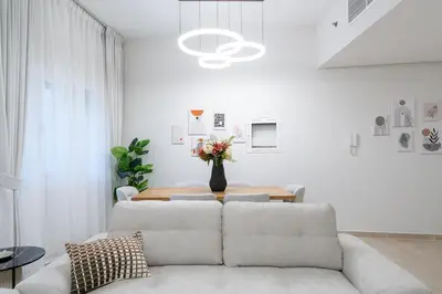 a living room with a couch and a table at Veluxa - Renovated 1BHK next to Golf in Dubai