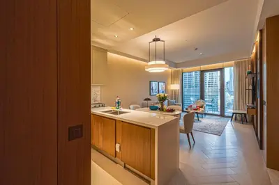 a kitchen and living room with a dining room at Venetian - Stay at Address Opera with Burj & Fountain views in Dubai