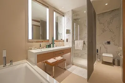 a bathroom with a tub and a sink and a shower at Venetian - Stay at Address Opera with Burj & Fountain views in Dubai