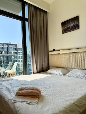 a hotel room with a bed and a large window at Azizi Rivera 33 in Dubai