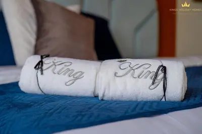 two towels with the word king written on them on a bed at Dunya Tower Royal suites in Dubai