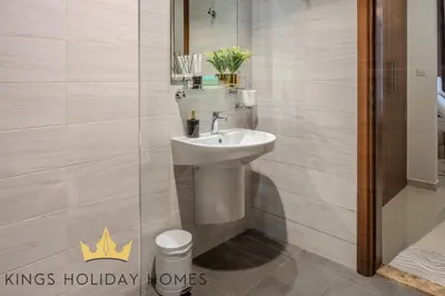 a bathroom with a sink and a toilet at Dunya Tower Royal suites in Dubai