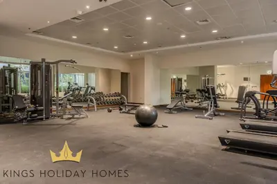 a kings holiday homes gym with weights and exercise equipment at Dunya Tower Royal suites in Dubai
